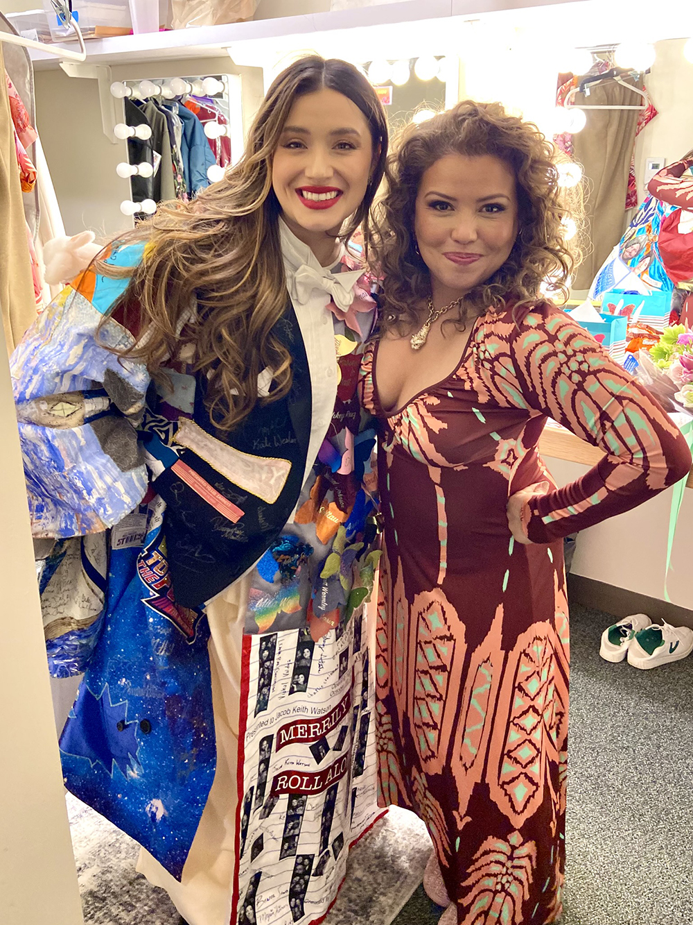 Ramirez, wearing the Robe, poses in a dressing room with Justina Machado.